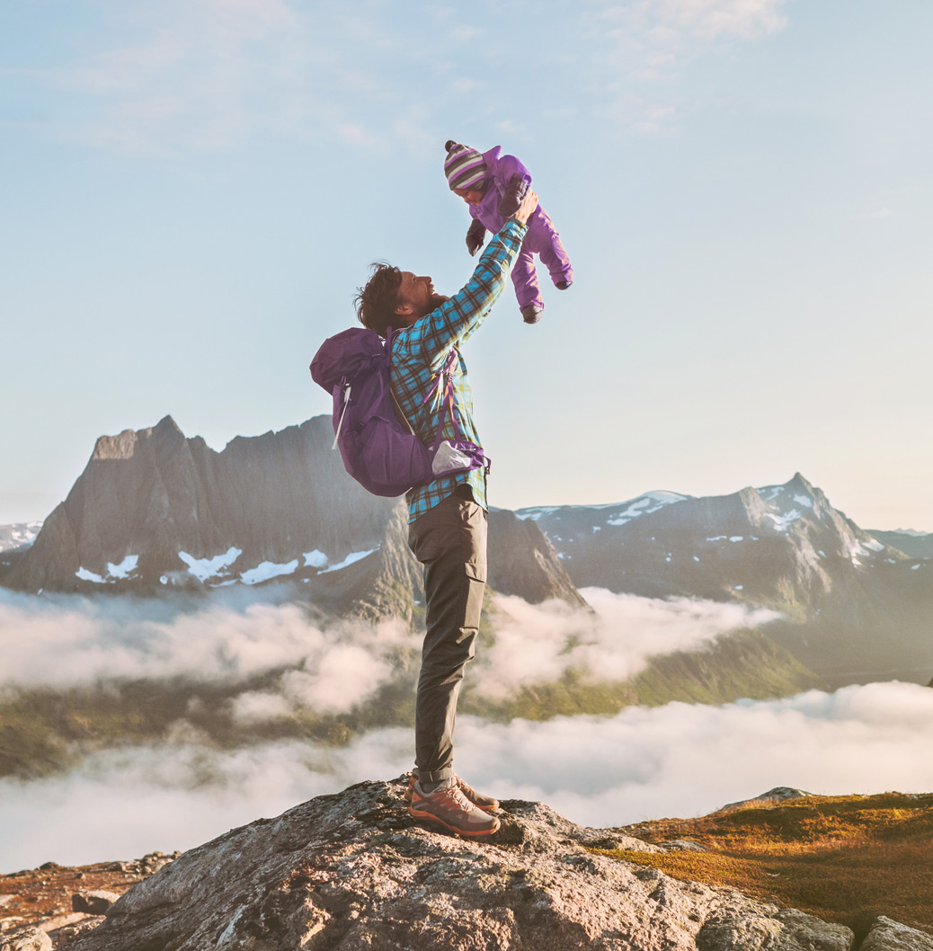 Parent lifting child on mountain with Viatris in Norway message, promoting global health at every life stage.